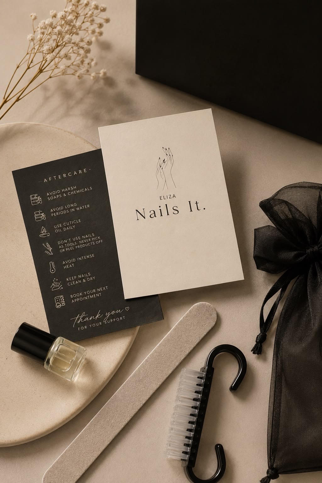 Eliza Nails It branded aftercare card and nail tools flat lay